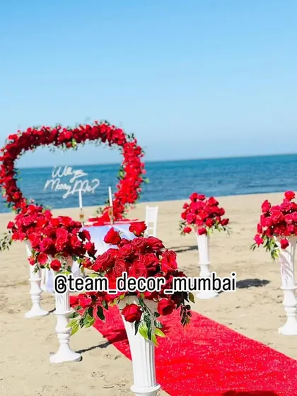 A slightly different angle of the beach proposal decor, showing the 'Will you Marry Me?' sign and the table setting more clearly. I ensure every detail is perfect for your photos.