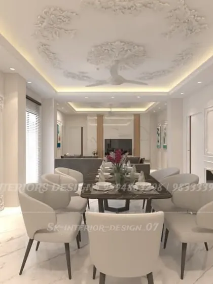 A wider view of the classic dining room, showing its connection to the living area. The intricate ceiling rose and cove lighting add a touch of timeless grandeur.