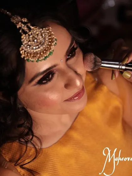 Duplicate of 22. This action shot shows the careful technique used to apply powder products for a seamless blend.
