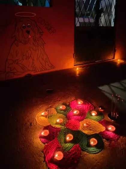 A special corner dedicated to our angel, Toffee, beautifully lit with a colorful diya rangoli for Diwali.
