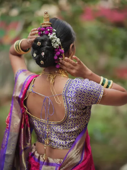 A complete bridal artist needs to be a skilled hairstylist. I teach traditional hairstyles like this intricate Maharashtrian khopa, beautifully adorned with fresh flowers, a timeless look for any bride.