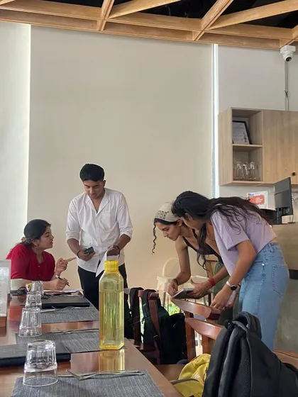 Sometimes we take our classes off site. Here, students are engaged in an interactive session at a local cafe, applying their language skills in a new environment.