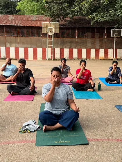 Students practicing pranayama (breathing exercises) outdoors. Connecting with the breath is even more powerful when surrounded by fresh air and nature.