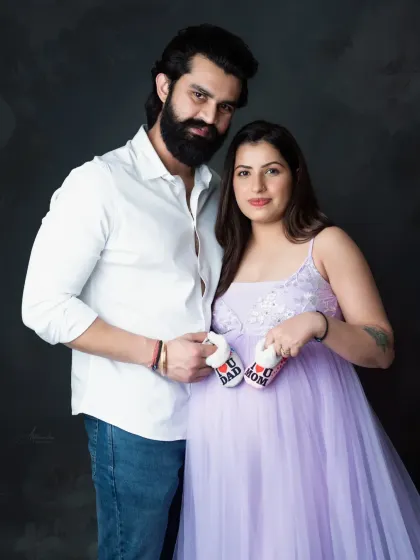 A sweet and classic couple's portrait. Holding the baby shoes together is a simple yet powerful symbol of the new life you're about to welcome.