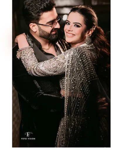 A candid moment of laughter and connection. This photo shows the couple enjoying their party, with a natural and joyful interaction that we love to capture.