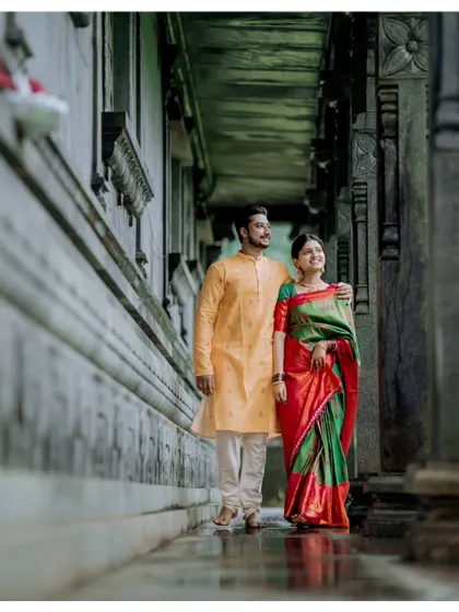 A beautiful shot of a couple walking through a temple corridor, framed by ancient pillars, creating a timeless and elegant pre-wedding photograph.