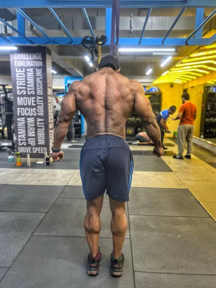 A full back shot displaying width and definition. It's not about being perfect; it's about the effort you put in daily. That is where real transformation happens.