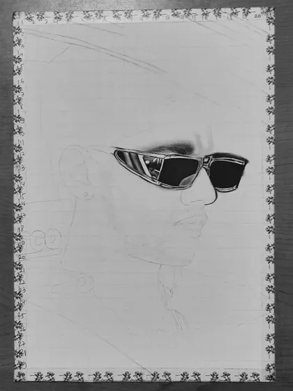 A step-by-step look at my 85-hour portrait of Baseer Ali. You can see the grid lines and how I build up the layers of graphite and charcoal to create a photorealistic effect.