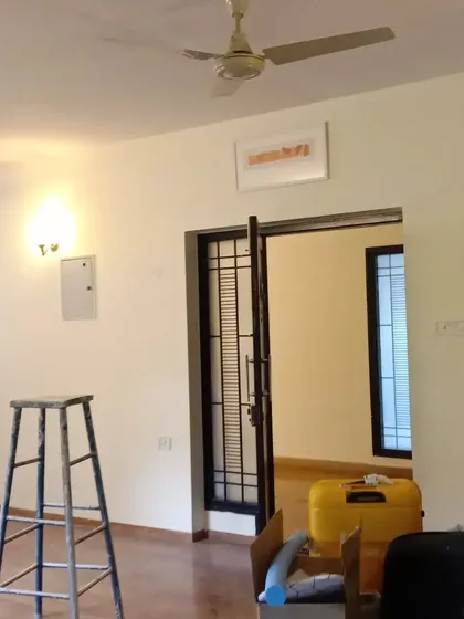 A living area during the painting process. The presence of a ladder and equipment shows an active worksite, where we are focused on delivering a quality result.