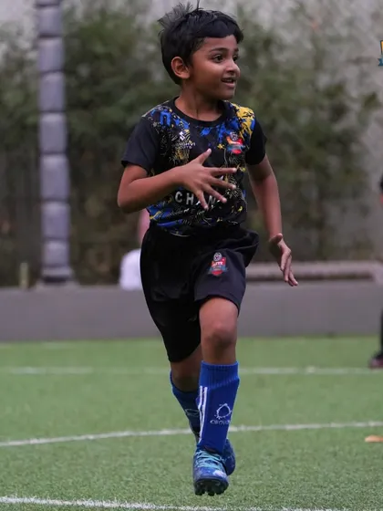 Running towards the goal. An action shot of a young player sprinting on the turf, embodying the energy and drive we instill in our academy members.