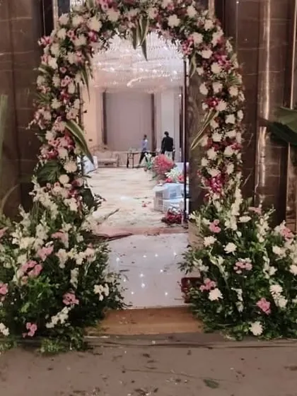 The same floral entrance arch, showing how it frames the view into the main event space.
