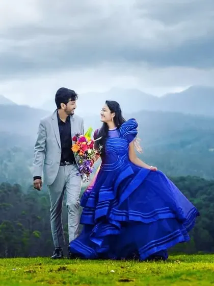 A candid moment between the couple during their photoshoot in the mountains. Even from a distance, the coordinated outfits and her elegant hairstyle create a picture-perfect scene.