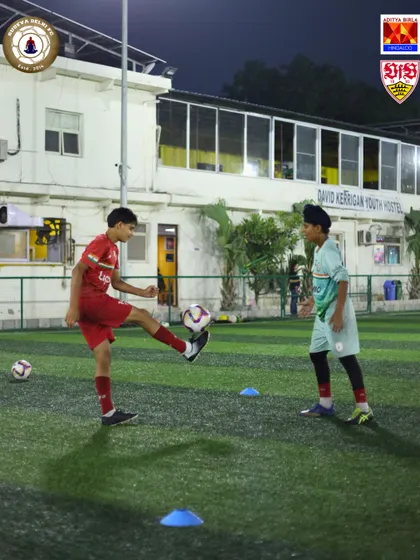 Two players engage in a passing drill, focusing on precision and timing. Teamwork starts here, with simple, effective communication on the pitch.