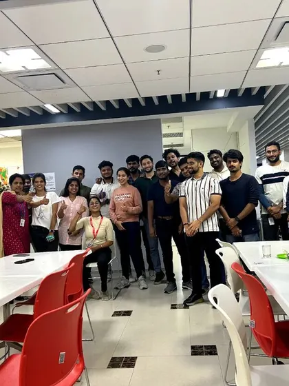 A cheerful group photo after a successful and energizing chair yoga session in the office cafeteria.