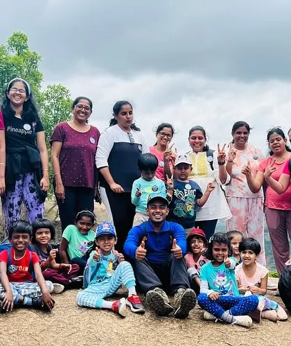 A candid moment with the mothers and children resting on the rocks during their hike.