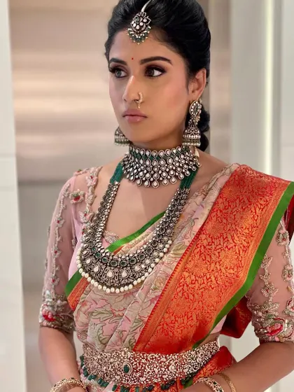 A side profile showing the intricate details of the jewelry and the soft makeup.
