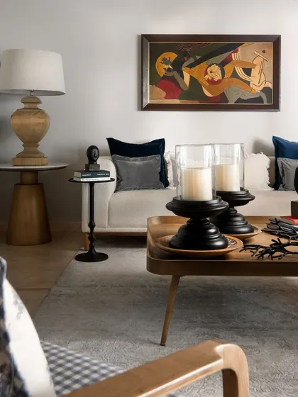 An immersive painting by maestro MF Husain finds a place of pride in this living room, becoming the focus wall. The contemporary furniture and curated decor were chosen to complement this masterpiece.