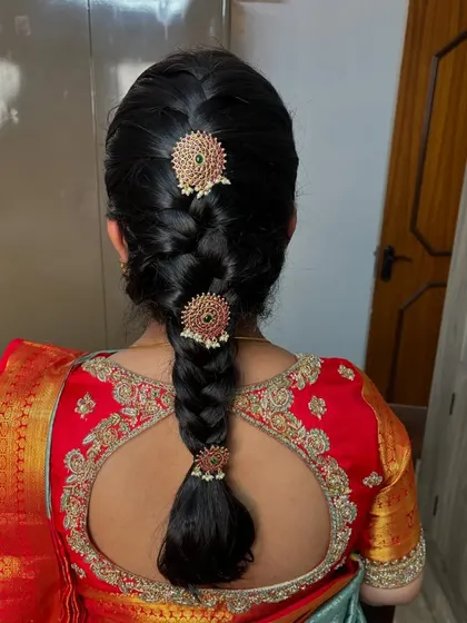 A simple yet elegant braid adorned with three matching jeweled pins. This look is perfect for a guest or for pre-wedding functions.