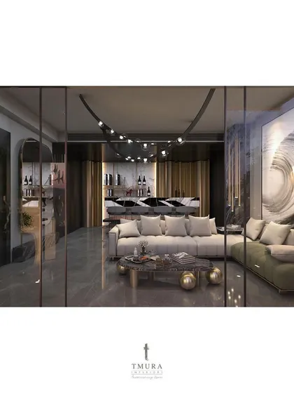 This lounge and bar area is designed for stylish entertaining. A large abstract painting provides a dramatic backdrop, while the custom lighting fixture follows the curve of the ceiling, guiding the eye towards the bespoke bar.