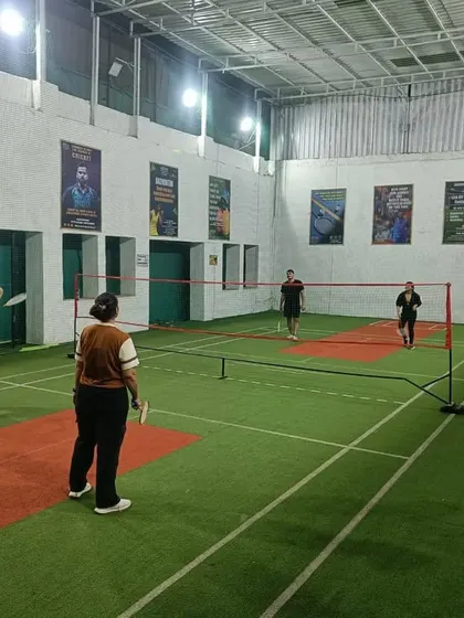 Intense focus during a mixed doubles game. The players are ready to return a fast shot at the net.