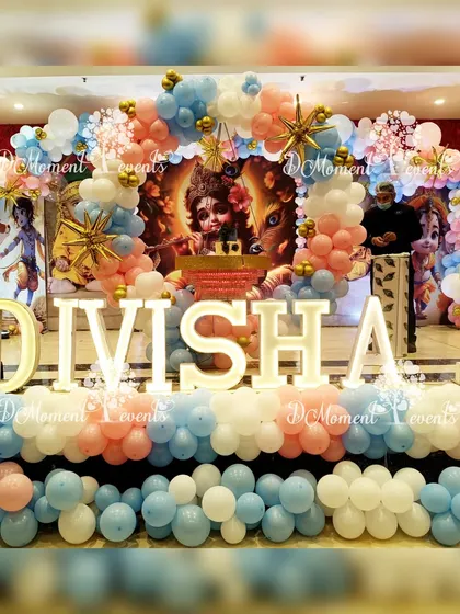 A wide shot of the Krishna-themed stage, showing the full scale of the decorations and the beautiful blend of traditional and modern elements.