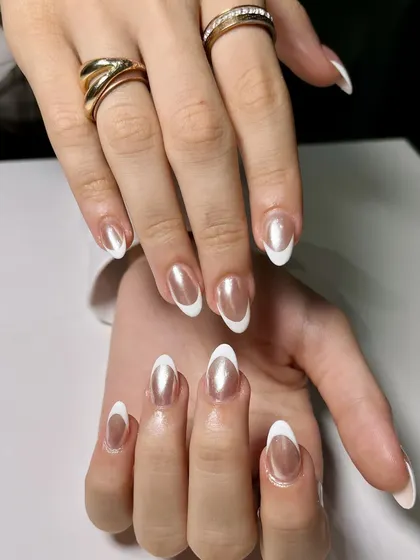 Here, I've combined a classic white French tip with a shimmery chrome base. The result is a modern, elegant look that catches the light beautifully.