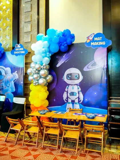 A 'Mat Making' craft station set up with a space theme, providing a quiet and creative activity for party guests.