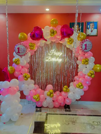 A different view of the pink and gold first birthday ring backdrop.