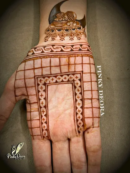 The basic grid and outline for a Karwa Chauth design. This shows the careful planning that goes into creating a balanced and beautiful piece of mehndi art.