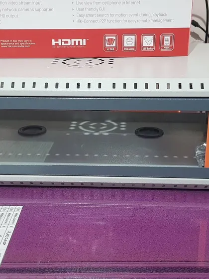 A network rack with a Hikvision Embedded NVR box on top, part of an IP camera installation.