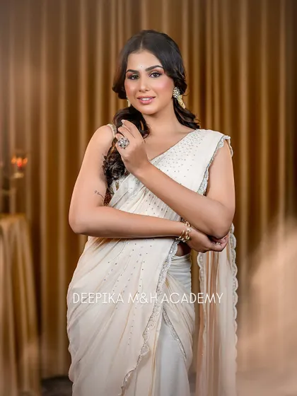 A full-length shot of the model in the beautiful white saree. The look is sophisticated and perfect for a formal party or reception.