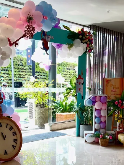The entrance to Ahana's 'Onederland' party. We created a large frame with a balloon arch, a giant clock, and a storybook sign to set the magical tone right from the start.