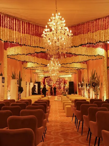 The view from the back of the hall, capturing the sheer scale and impact of the floral ceiling installation. The design transforms the entire venue into a fragrant, festive sanctuary.
