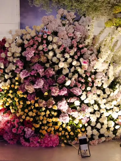A close-up of the dense floral work used in the reception decor. I layered different flowers like roses and hydrangeas in various shades of pink, white, and yellow to create rich texture and dimension.