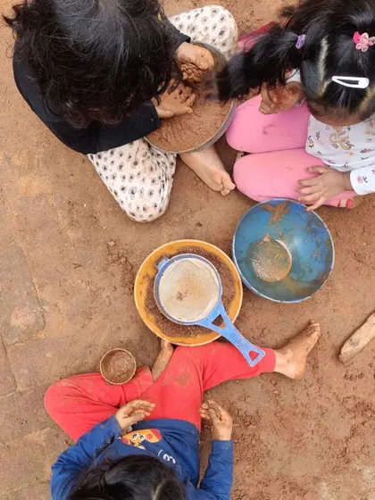 An aerial view of our "mud kitchen" in full swing, with children working independently and together on their imaginative projects.
