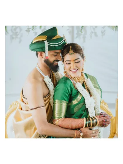 A happy portrait of a South Indian couple embracing after their wedding rituals.