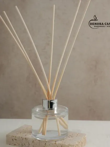 A closer look at the silver-capped reed diffuser. The clear glass bottle and natural reeds create a timeless aesthetic that complements any interior design style.