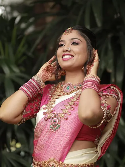 A joyful moment captured. The bride's smile is the perfect complement to the stunning traditional jewellery she chose for her wedding day.