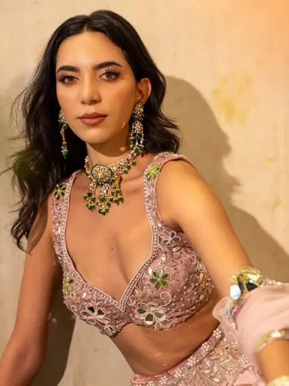 A close-up on a beautiful emerald and polki set from Virok by Tatiwalas, paired with a pastel pink mirror-work lehenga. The right jewellery can elevate any outfit.