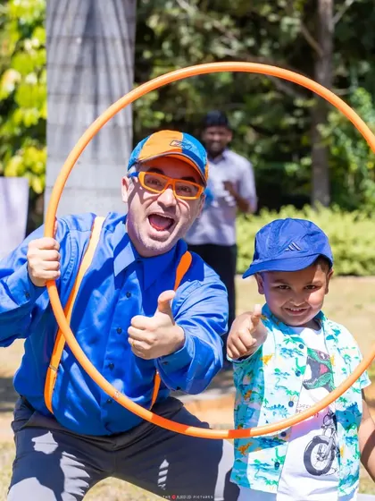 The birthday boy and his hero, Blippi, posing with a hula hoop. I arranged for this character appearance as a special surprise.