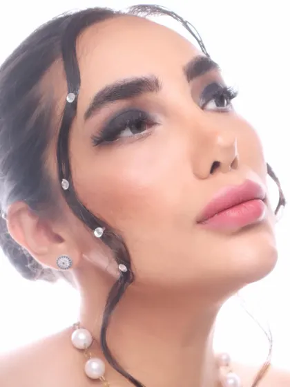 A close-up of a conceptual makeup look. I used rhinestones to create a unique hair detail, paired with a classic smokey eye.