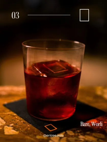 A classic dark cocktail from Bare, Worli. This photo captures a sophisticated and timeless vibe, appealing to users looking for a classic cocktail experience.