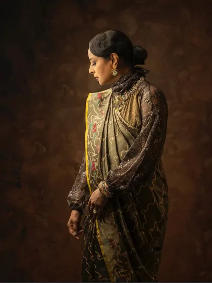 A vintage-inspired look for the campaign, with the saree draped to complement a high-neck lace blouse.