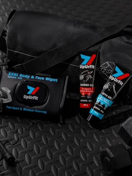 This lifestyle shot places UpUrFit's products in a gym bag setting. The textured, dark background and props reinforce the product's use case, making it relatable for fitness enthusiasts.