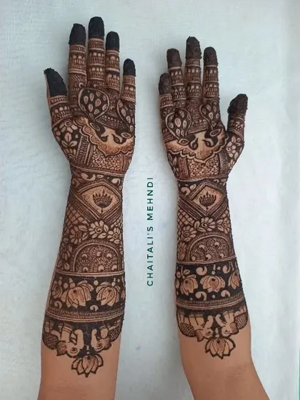 A full view of a traditional bridal mehendi with lotus and peacock designs. This style is perfect for brides who want a classic and timeless look for their wedding.