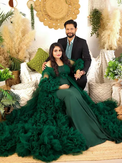 A stunning portrait of the couple in our lush, plant-filled boho set. Their coordinated green and black outfits create a look of pure glamour and sophistication.