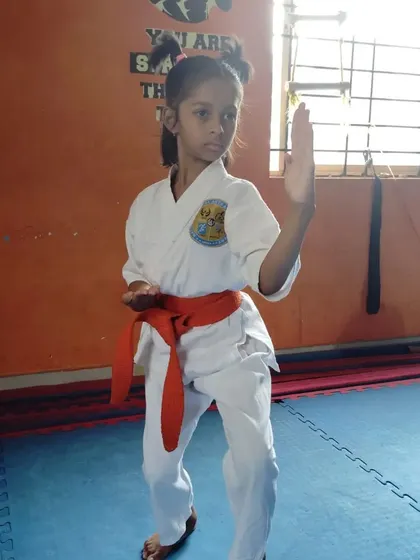This student practices a block, a fundamental defensive move in karate.
