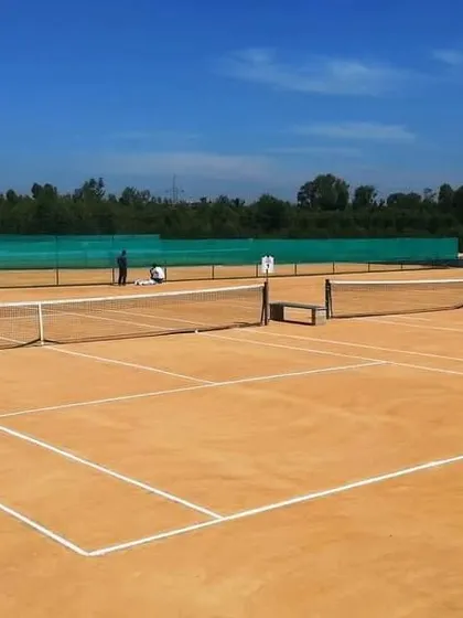 A clear view of one of our five championship-level clay courts on a perfect day for tennis. We keep the surface pristine and the lines sharp, ready for your next match or corporate tennis tournament in Bangalore.