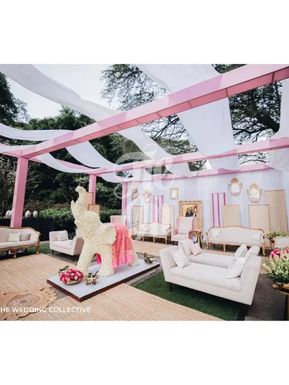 We designed comfortable and elegant lounge seating for guests, using soft pink and off-white tones to complement the overall decor. A floral elephant sculpture adds a touch of traditional charm to this modern setup.