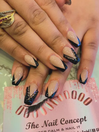 Edgy and glamorous, these coffin-shaped nails have a nude base with black V-tips. One accent nail on each hand features intricate black beadwork for added texture and detail.